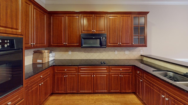 135 Coach Ln, Augusta, GA 30907 - kitchen with decorative backsplash, dark stone counters, ornamental molding, and black appliances