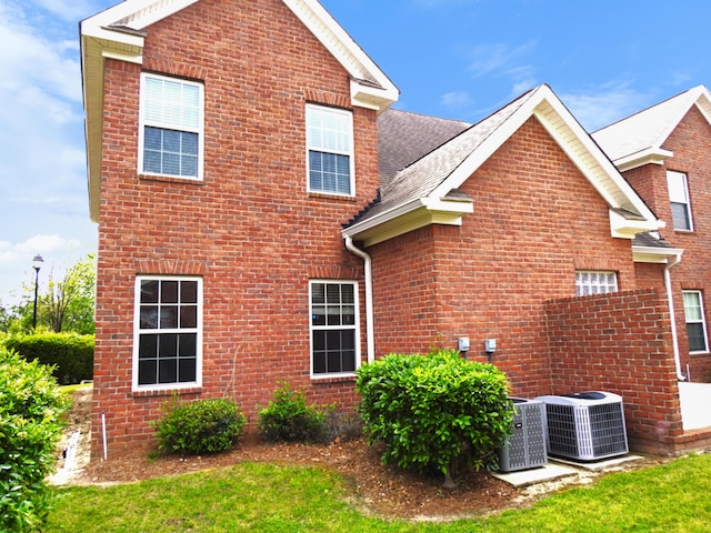 135 Coach Ln, Augusta, GA 30907 - view of side of property with brick siding, roof with shingles, and central AC