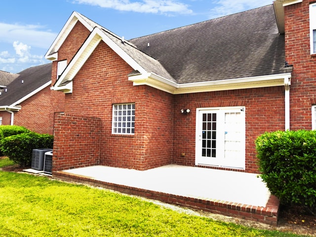 135 Coach Ln, Augusta, GA 30907 - back of house with central air condition unit, brick siding, and a shingled roof