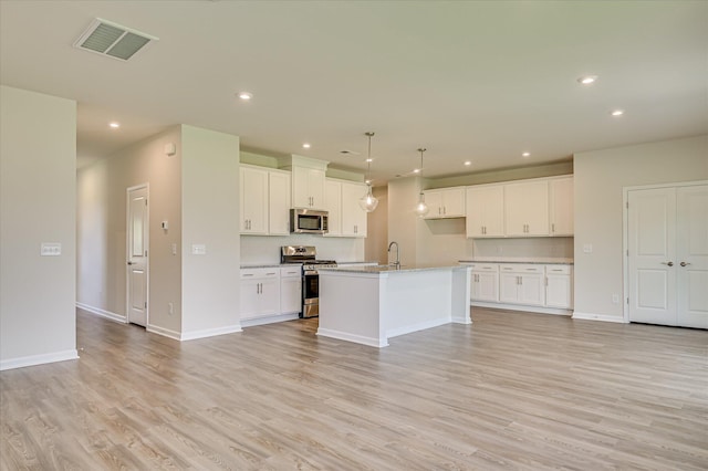 909 Kay Pl, Grovetown, GA 30813 - kitchen with appliances with stainless steel finishes, light wood-style flooring, recessed lighting, open floor plan, and white cabinets