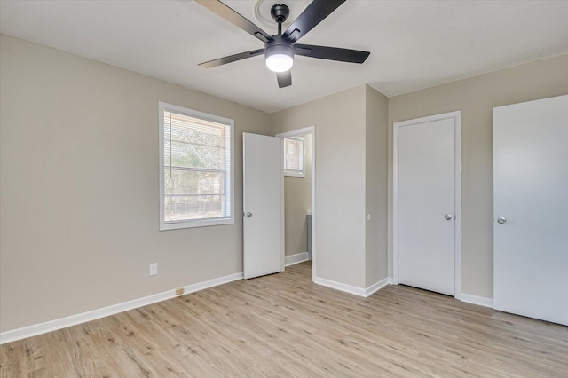 unfurnished bedroom featuring baseboards, ceiling fan, and light wood-style floors