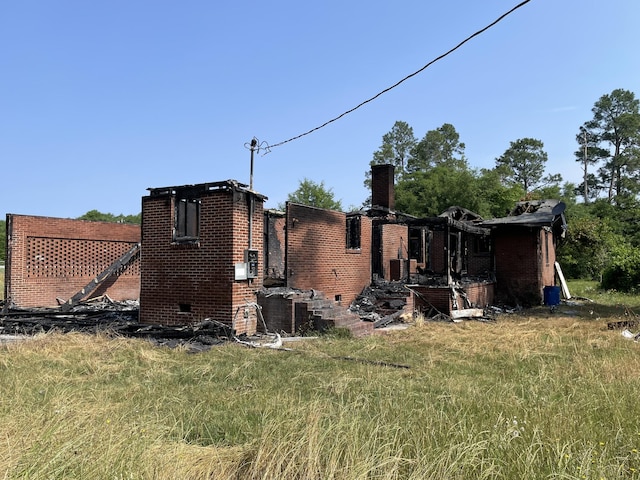 rear view of house featuring cooling unit