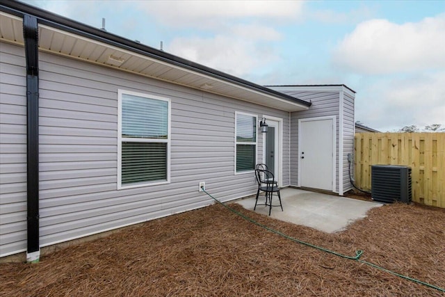 rear view of house with cooling unit and a patio