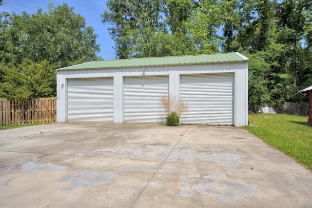 detached garage featuring fence