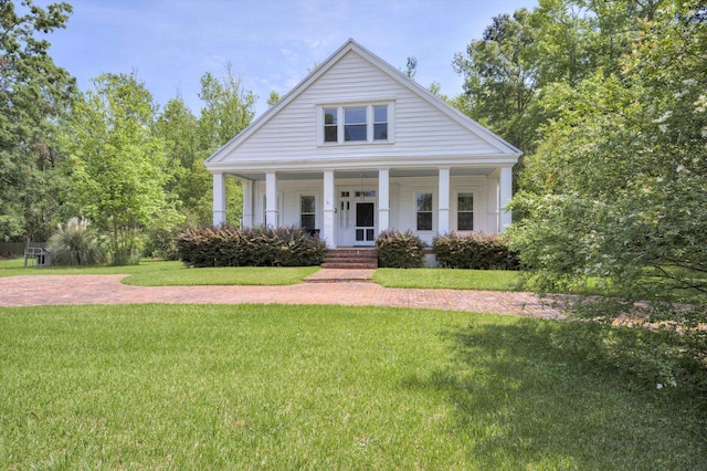view of front of home with a porch and a front lawn