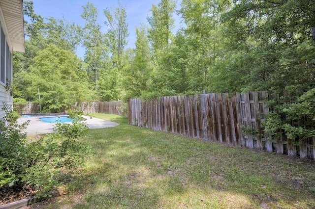view of yard featuring a fenced backyard, a fenced in pool, and a patio