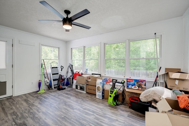 game room featuring baseboards, a textured ceiling, ceiling fan, and wood finished floors