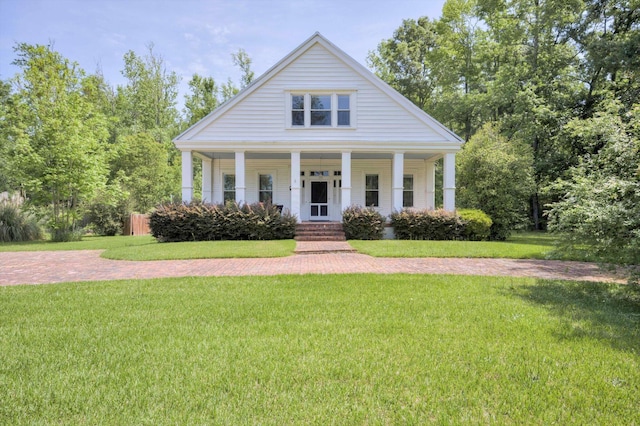 greek revival house featuring a front lawn and covered porch