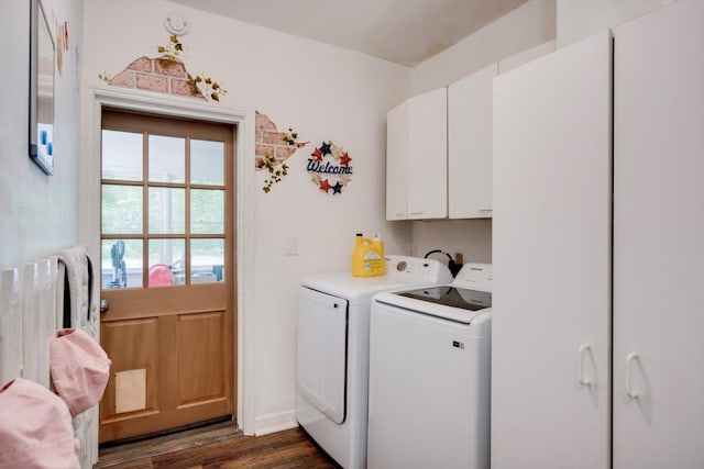 clothes washing area with cabinet space, dark wood finished floors, and washer and clothes dryer