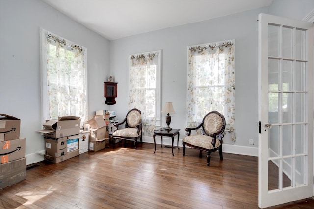 living area with baseboards and hardwood / wood-style floors