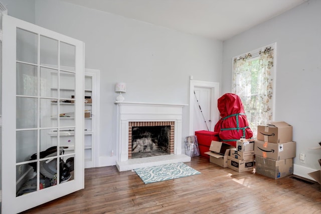 living room featuring wood-type flooring and a fireplace