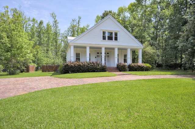 neoclassical home with fence, covered porch, and a front yard