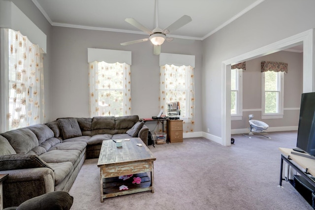 carpeted living room with crown molding, baseboards, and a ceiling fan