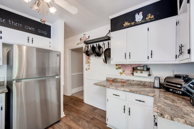 kitchen with white cabinets, freestanding refrigerator, and dark wood finished floors