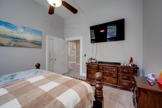 carpeted bedroom with high vaulted ceiling and ceiling fan