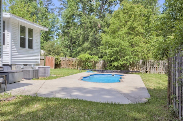 view of swimming pool with central AC, a fenced backyard, a fenced in pool, a patio area, and a yard