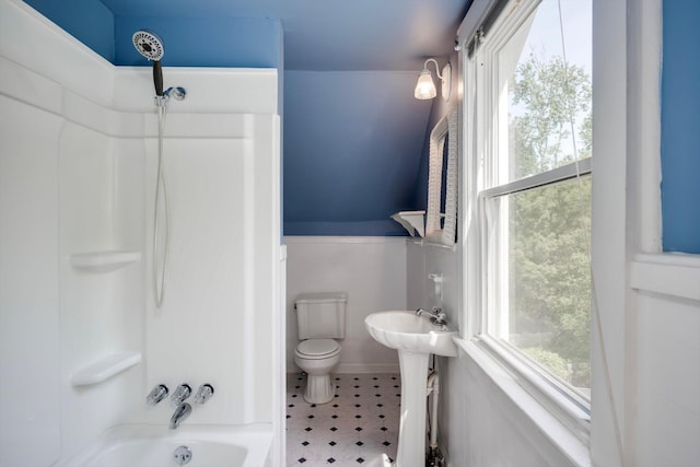 full bathroom featuring a sink, tile patterned floors, toilet, and shower / washtub combination
