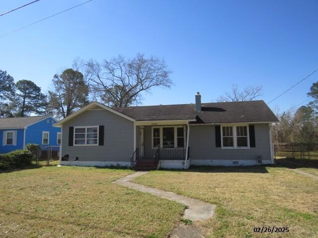 ranch-style home featuring covered porch, fence, crawl space, a front lawn, and a chimney