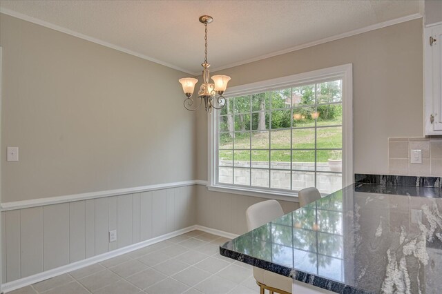 986 Campbellton Dr, North Augusta, SC 29841 - dining room with a chandelier, ornamental molding, light tile patterned flooring, and wainscoting