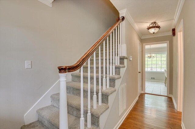 986 Campbellton Dr, North Augusta, SC 29841 - stairs with ornamental molding, wood finished floors, and a chandelier