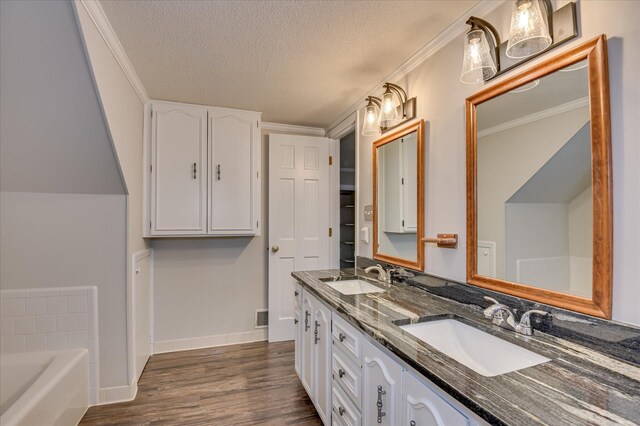 986 Campbellton Dr, North Augusta, SC 29841 - full bath featuring double vanity, a textured ceiling, wood finished floors, a bath, and crown molding