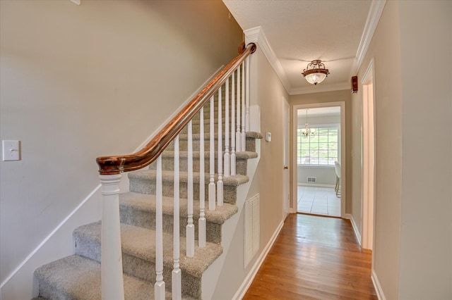 986 Campbellton Dr, North Augusta, SC 29841 - staircase featuring ornamental molding, wood finished floors, and a chandelier