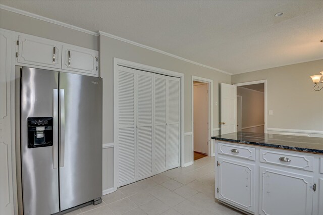 986 Campbellton Dr, North Augusta, SC 29841 - kitchen featuring stainless steel fridge with ice dispenser, crown molding, white cabinetry, light tile patterned flooring, and dark stone counters