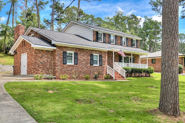 986 Campbellton Dr, North Augusta, SC 29841 - view of front of house with covered porch, a front yard, brick siding, and a chimney