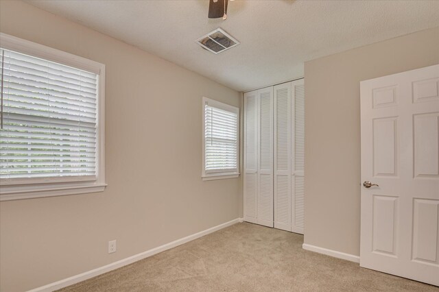 986 Campbellton Dr, North Augusta, SC 29841 - unfurnished bedroom featuring carpet flooring, a closet, multiple windows, and ceiling fan