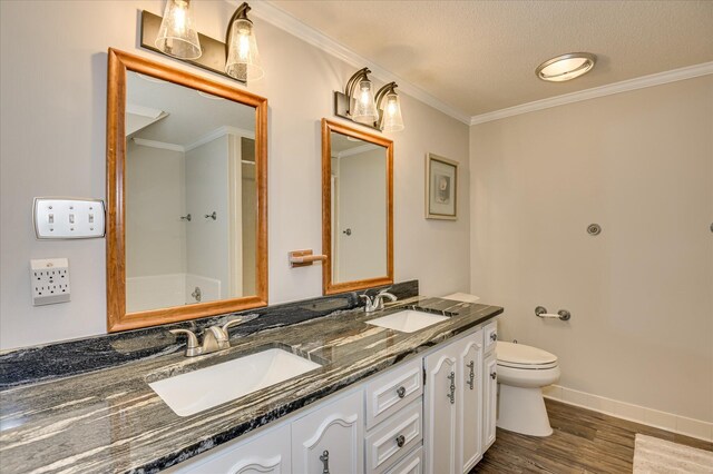986 Campbellton Dr, North Augusta, SC 29841 - bathroom with double vanity, wood finished floors, crown molding, and a textured ceiling