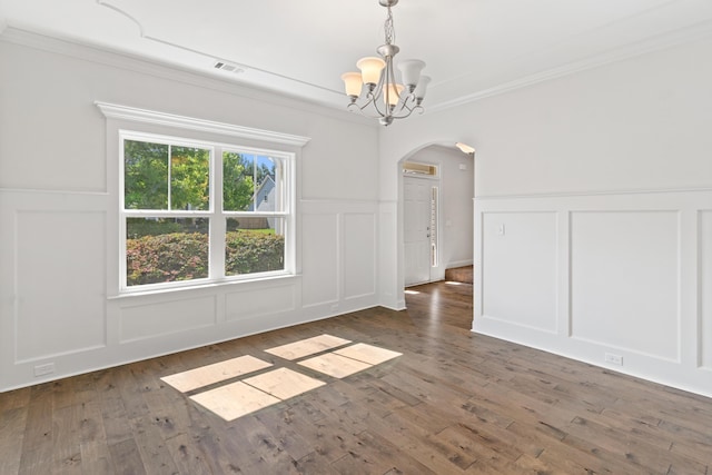 207 Hazelwood Ct, Grovetown, GA 30813 - spare room featuring a decorative wall, arched walkways, a chandelier, ornamental molding, and wood finished floors