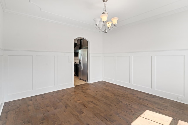 207 Hazelwood Ct, Grovetown, GA 30813 - unfurnished dining area with a decorative wall, arched walkways, crown molding, a chandelier, and a wainscoted wall
