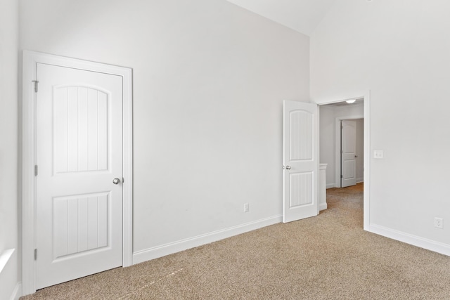 207 Hazelwood Ct, Grovetown, GA 30813 - spare room featuring carpet, baseboards, and high vaulted ceiling