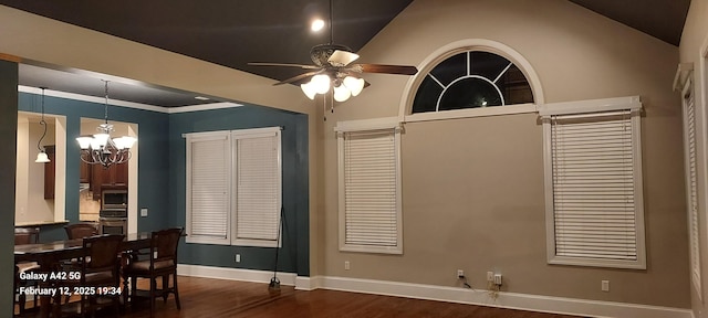 dining space featuring baseboards, lofted ceiling, ornamental molding, dark wood-type flooring, and ceiling fan with notable chandelier