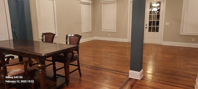 dining room featuring dark wood-style floors and baseboards