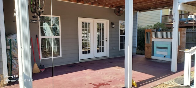 view of exterior entry with a patio area