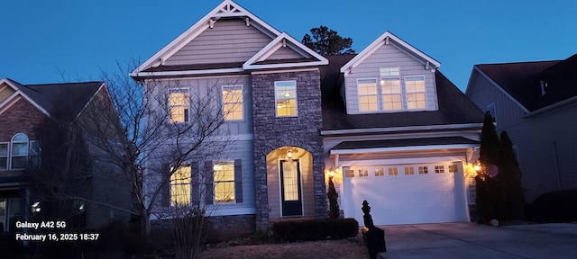 view of front of house featuring driveway and stone siding