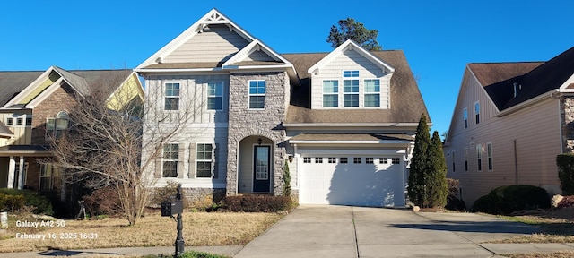 view of front facade featuring stone siding, an attached garage, and concrete driveway