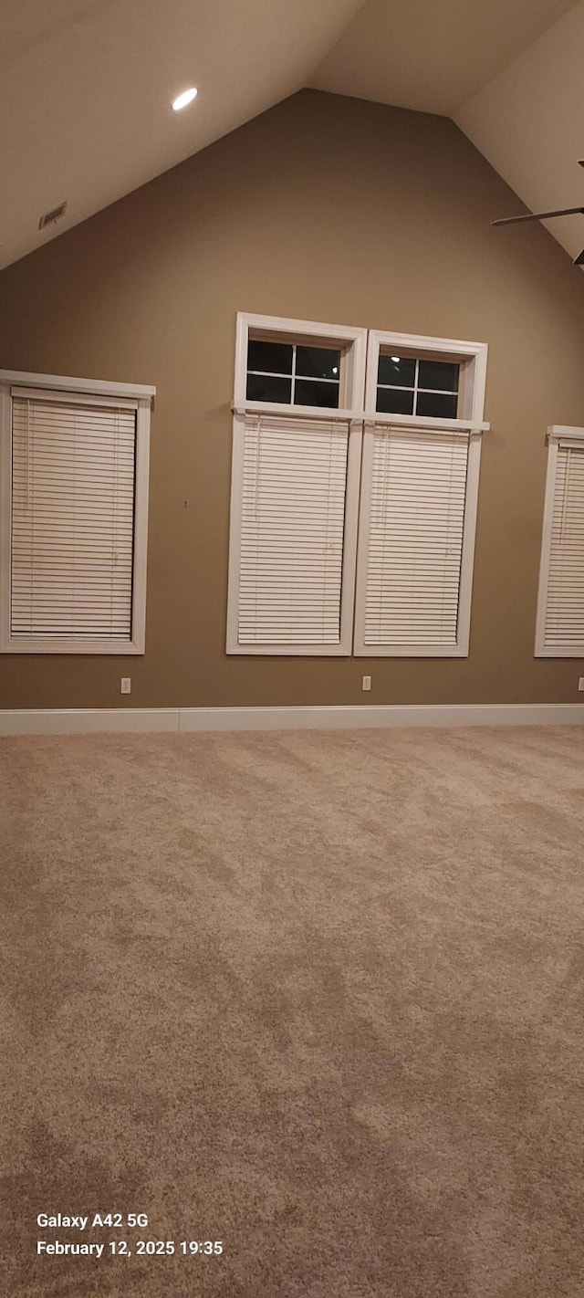 empty room featuring lofted ceiling, recessed lighting, carpet, and baseboards