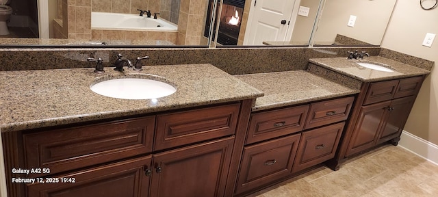 full bathroom featuring a tub, tile patterned flooring, and vanity