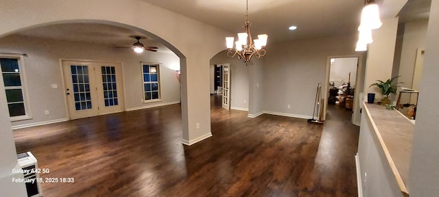 dining room featuring arched walkways, dark wood-style flooring, recessed lighting, baseboards, and ceiling fan with notable chandelier