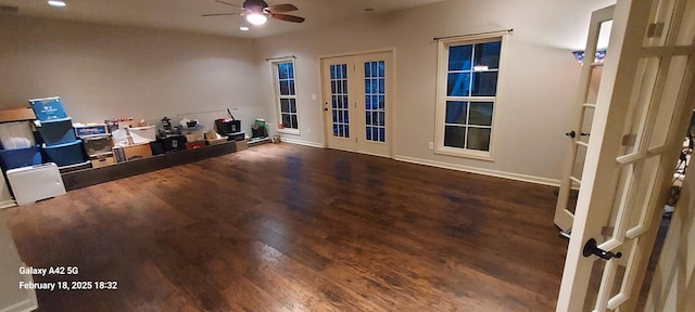 interior space with a ceiling fan, dark wood-type flooring, and french doors