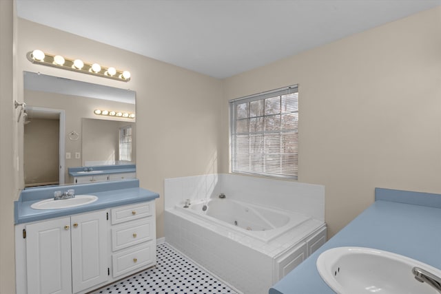 bathroom with a whirlpool tub and vanity