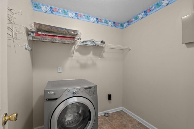 laundry room with laundry area, washer / clothes dryer, and baseboards