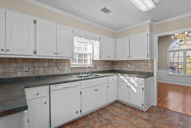 kitchen with dishwasher, dark countertops, white cabinets, and a sink