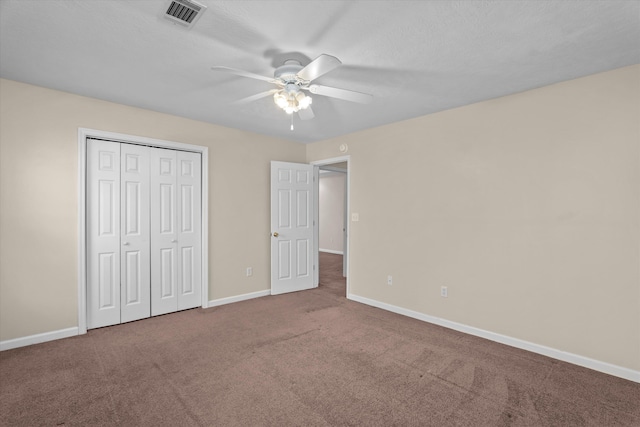 unfurnished bedroom featuring visible vents, a ceiling fan, a closet, carpet floors, and baseboards