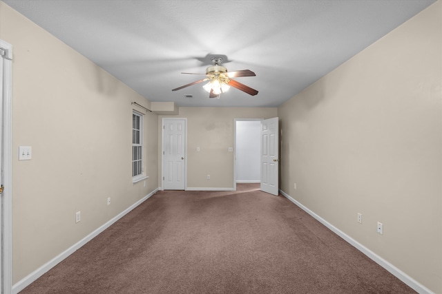 carpeted spare room with baseboards and ceiling fan