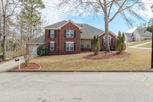 view of front of house featuring a front yard, roof with shingles, an attached garage, concrete driveway, and brick siding