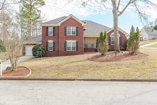 view of front of home featuring brick siding, an attached garage, driveway, and a front lawn