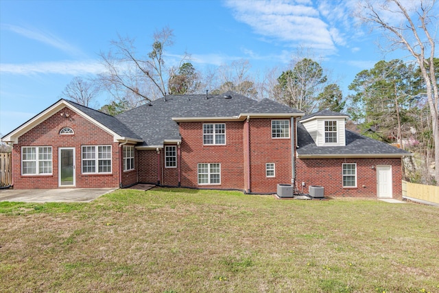 rear view of house with a patio area, a lawn, central AC, and fence